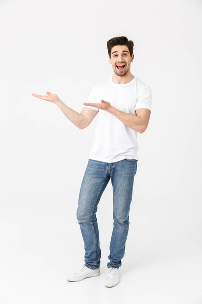 Excited young man posing isolated over white wall background. - Foto, immagini