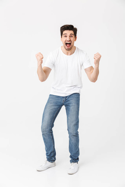 Excited happy young man posing isolated over white wall background. - Фото, зображення