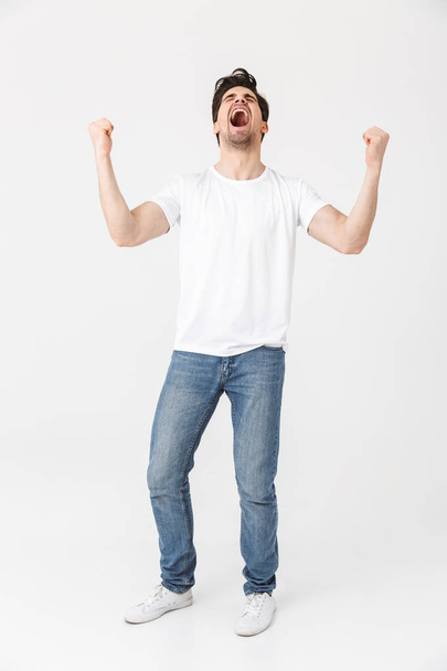 Excited happy young man posing isolated over white wall background. - Foto, Imagem
