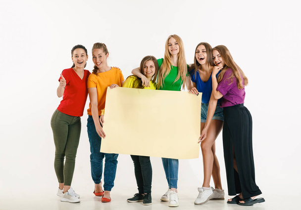 Young people weared in LGBT flag colors isolated on white background, LGBT pride concept - Photo, Image