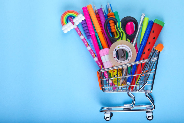 Banner of Shopping cart with school supply on a blue background with copy space. Back to school - Фото, зображення