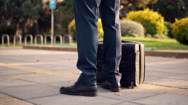 Indian businessman wearing blue suit standing with travel bag or suitcase - Footage, Video