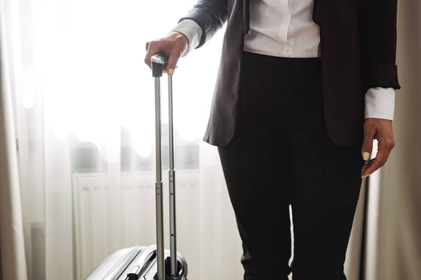 Cropped image of a beautiful young business woman with suitcase. - Foto, Bild