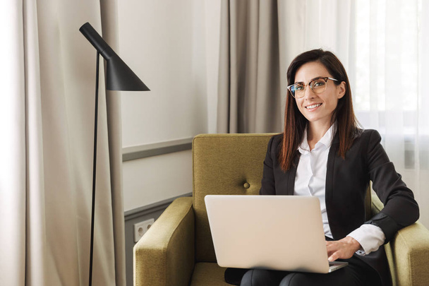 Business woman in formal wear clothes indoors at home work with laptop computer. - Foto, Bild
