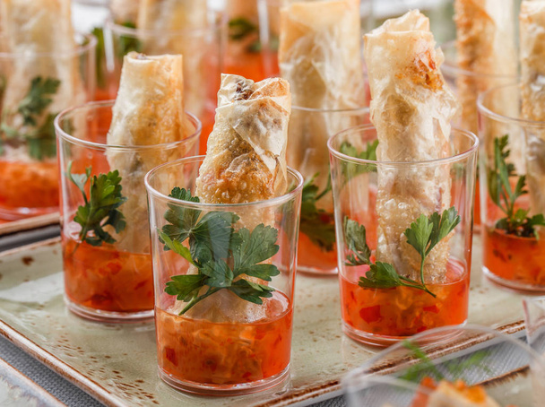 Delicious appetizers in glass cups on banquet table. Catering food, canape and snacks - Photo, Image