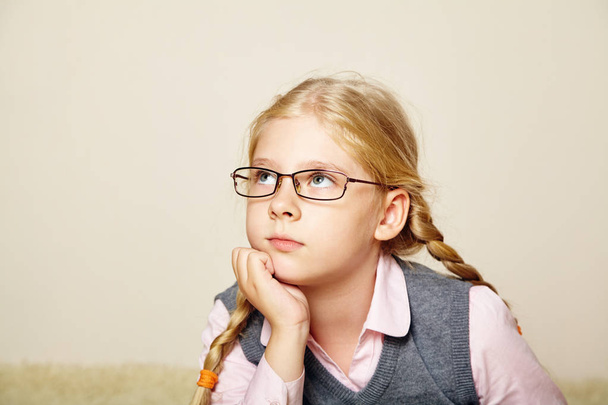 portrait of a schoolgirl with glasses. child at home. - Fotó, kép