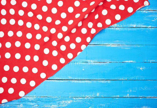 red textile towel with white circles on a blue wooden background - Photo, Image