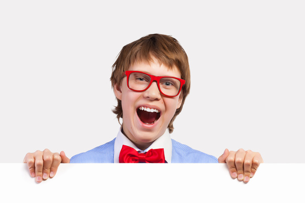 Boy in red glasses holding white square - Foto, Imagen