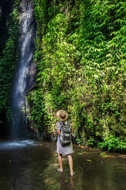 Woman near waterfal on Bali, Indonesia  - Φωτογραφία, εικόνα