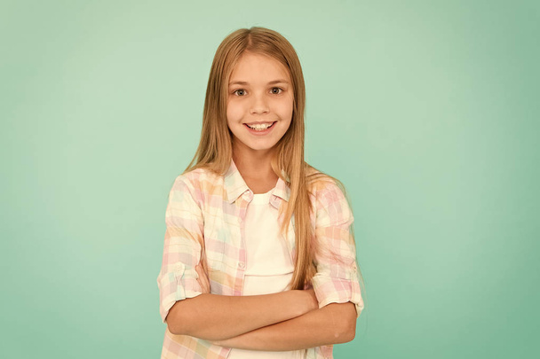 Kid girl blonde hair posing confidently. Girl feels confident with crossed arms. Child hold hands confidently crossed chest. Child psychology and development. Confident posture. Upbringing confidence - Фото, зображення