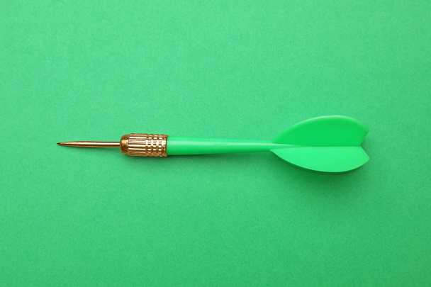 Plastic dart arrow on green background, top view - Photo, image