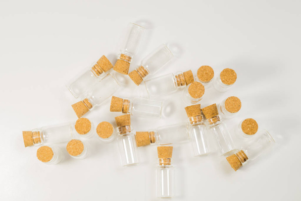 Empty little bottles with cork stopper isolated on white. transparent containers. test tubes - 写真・画像