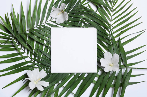 Flat lay composition with tropical leaves and Hibiscus flowers on white background. Space for text - Fotoğraf, Görsel