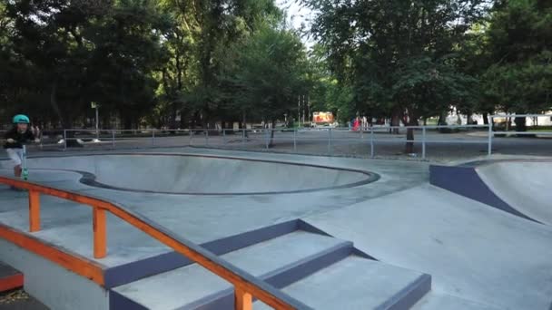 schoolboy jumps from stairset and rides along skate park - Filmati, video