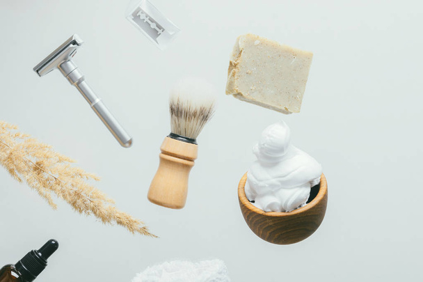 set for shaving with metal safe razor, wooden brush and soap. - Фото, изображение