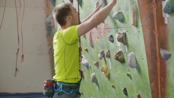Climber attaching a belay rope and Chalking hands - Footage, Video