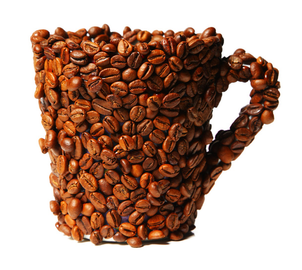 Mug covered with coffee beans isolated on white - Fotó, kép