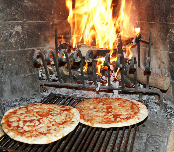 excellent fragrant pizza baked in a wood fireplace with a wood-b - Photo, Image