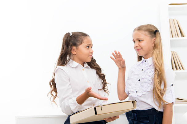 Discussing homework. Help with project. Schoolgirls study together. Education concept. Group activity. Little schoolgirls classmates friendly kids. Hard task. Schoolgirls working school project - Photo, image