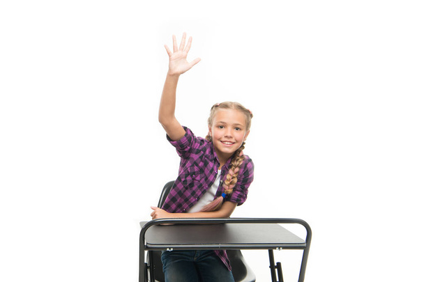 She is a bright student. Small girl student raising hand isolated on white. Little student reciting lesson in class. Cute lyceum student sitting at desk - Photo, image