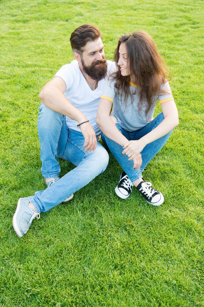 Being in love. perfect date. family weekend. couple in love. valentines day. cute girl and bearded man hipster on green grass. summer relax in park. romantic couple having fun together - Photo, Image