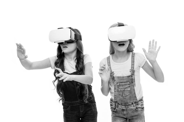 Virtual reality is exciting. Girls little kids wear vr glasses white background. Virtual education concept. Modern life. Interaction in virtual space. Cyber gaming. Augmented reality technology - Foto, Bild