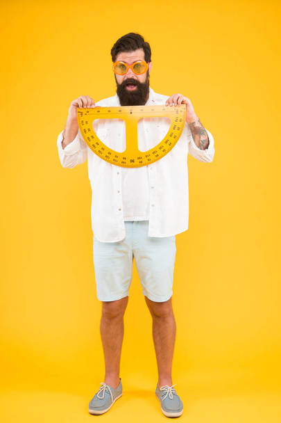 Student using measuring instrument. Barber hairdresser salon. Maintain beard shape. Bearded nerd with protractor. Exploring properties of protractor. Brutal hipster hold protractor for math lesson - Foto, Imagem