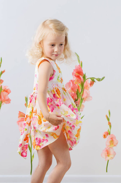 beautiful little blonde girls with  flowers on white background - Fotó, kép