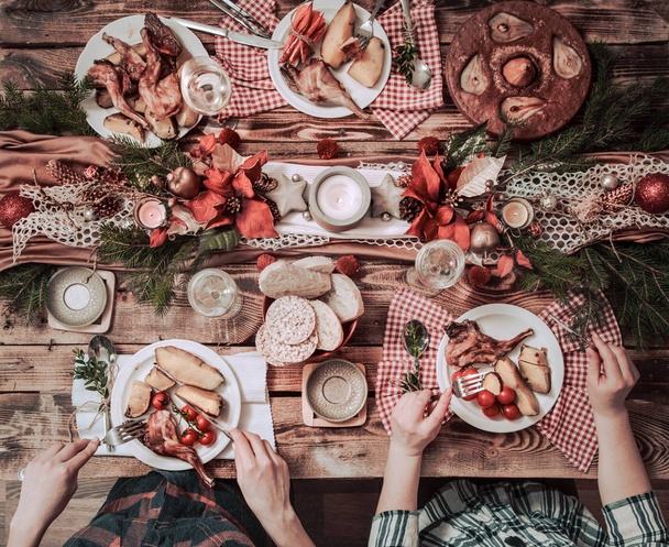 Flat-lay of friends hands eating and drinking together. Top view - 写真・画像