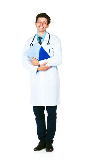 Full length portrait of a smiling male doctor holding a notepad - Fotografie, Obrázek