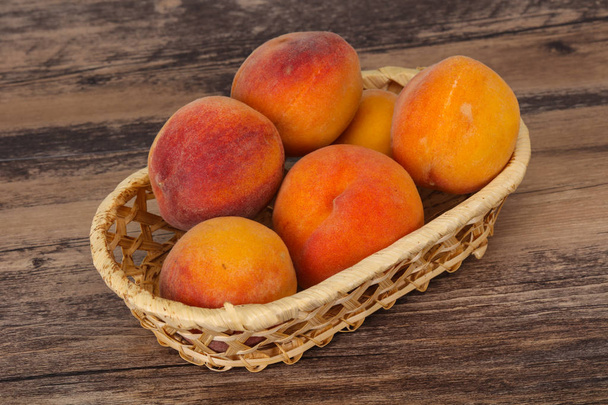 Peach heap in the wooden basket - Photo, Image