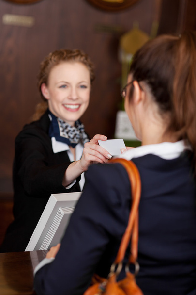 Guest receiving a business card at reception - Fotoğraf, Görsel