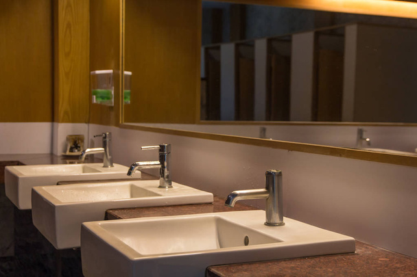  White wash bowl row in modern restroom interior, wash basin back
 - Фото, изображение