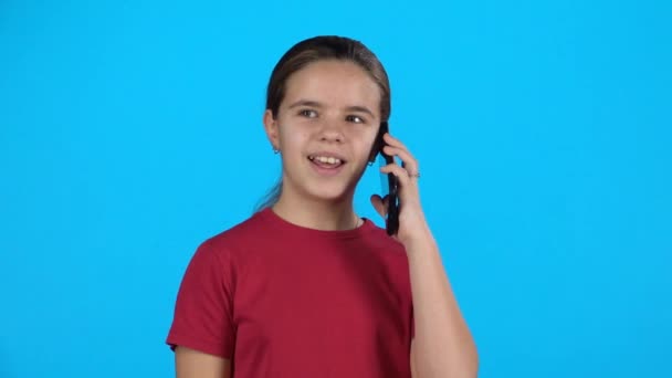 Little girl on cell phone talking. Slow motion - Footage, Video