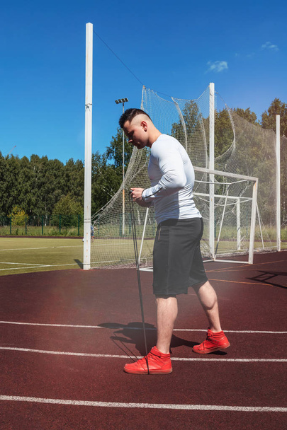 athletic man at the stadium with a rope. Healthy lifestyle. Sport activities on the street - Photo, Image