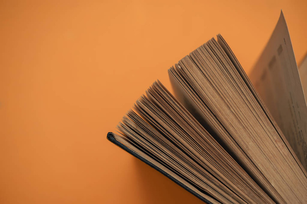 Open book on a yellow background. Top view. - Photo, Image