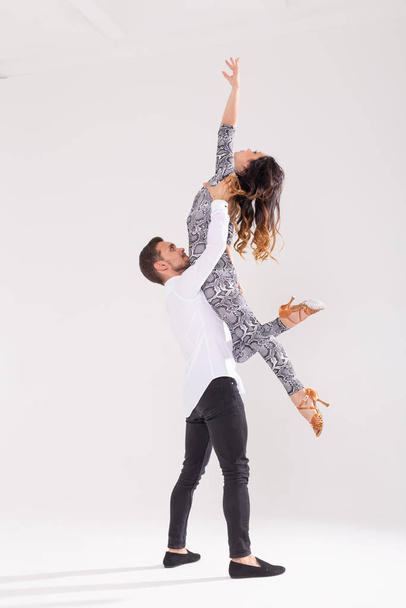 Молодая пара любит танцевать социальный данс кизомба или бачата на белом фоне с копировальным пространством
 - Фото, изображение