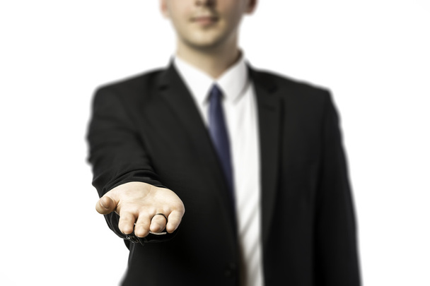 Businessman in dark suit holds out his hand flat - Photo, Image