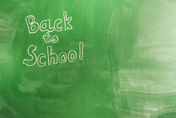 Back to school concept with written words in chalk on green blackboard. The beginning of the school year - 写真・画像