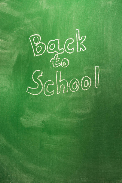 Back to school concept with written words in chalk on green blackboard. The beginning of the school year - Фото, изображение