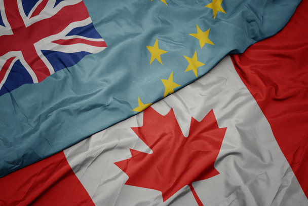 waving colorful flag of canada and national flag of Tuvalu. - 写真・画像