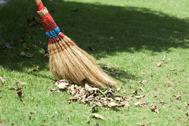 Gardener is collecting leaves during autumn season  - Photo, Image
