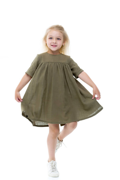 A little girl in a dress is spinning. - Fotografie, Obrázek
