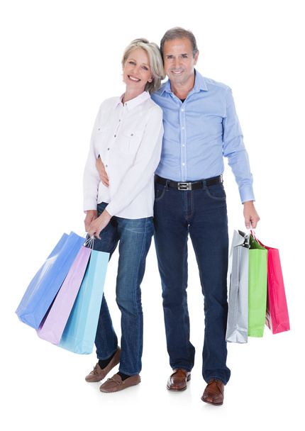 Mature Couple Holding Shopping Bags - 写真・画像