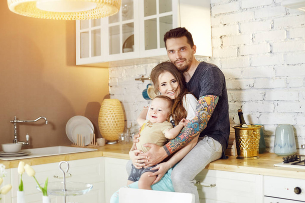 Couple and their little baby baby in arms. Young family at home  - Фото, зображення