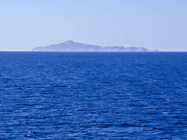 Island in Aegean sea covered with windmils for electricity production. Renewable energy sources  concept. - Photo, Image