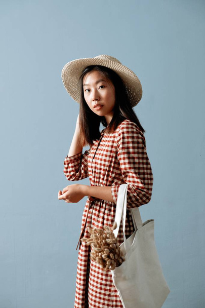 Meditatively Asian Beautiful Young Woman with Bag - 写真・画像