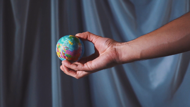 The hand is holding and throwing up the globe. The world is in your hands. Slow motion - 映像、動画