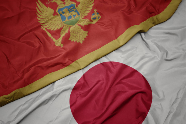 acenando bandeira colorida do japão e bandeira nacional de Monten=
. - Foto, Imagem