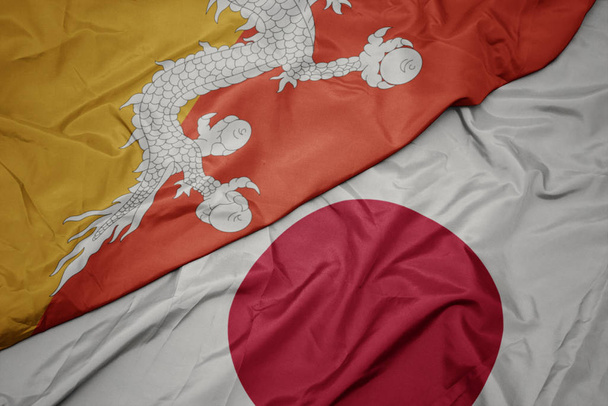 acenando bandeira colorida do japão e bandeira nacional do Butão
. - Foto, Imagem